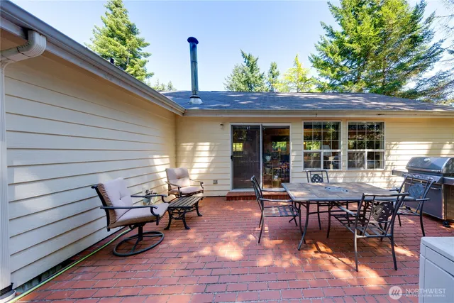 a view of a backyard with a dining space and a patio
