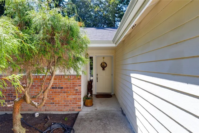 a living room with furniture fireplace and a large window