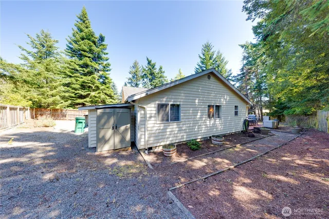 a view of a house with backyard and sitting area