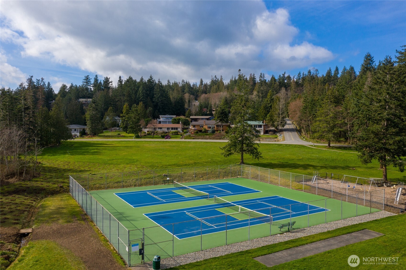 399 Tilingit Place La Conner, WA 98257 - Photo 37 of 39 a view of a tennis ground with large trees