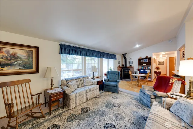 a living room with furniture a large window and a flat screen tv