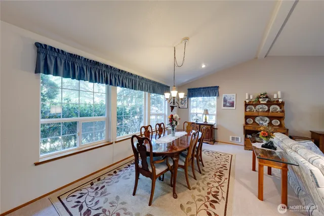 a living room with furniture a rug and a large window