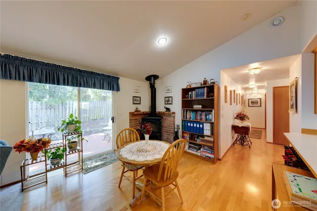 a living room with furniture kitchen view and a large window