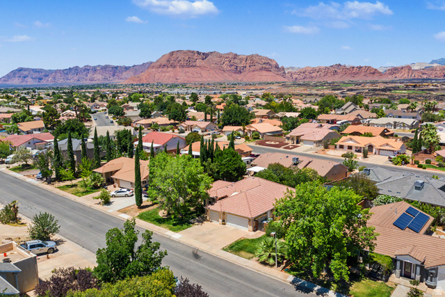 3034 Swiss Drive Santa Clara, UT 84765 - Photo 54 of 59 Residential neighborhood with a backdrop of red rock mountains and a clear sky