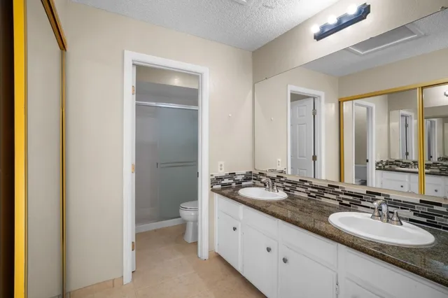 a bathroom with a double vanity sink and a mirror