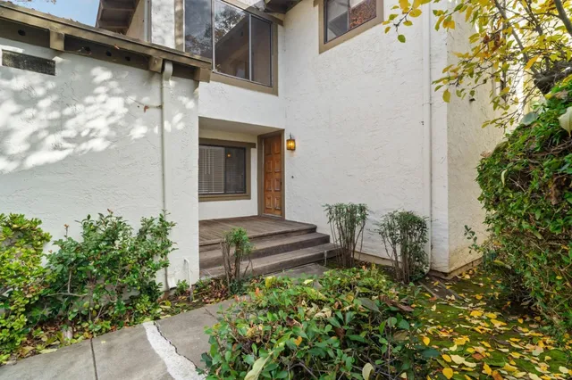 a front view of a house with a garden