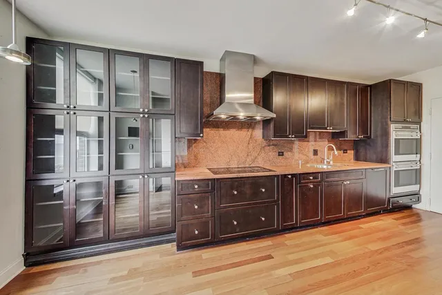 a kitchen with stainless steel appliances granite countertop a refrigerator and a sink