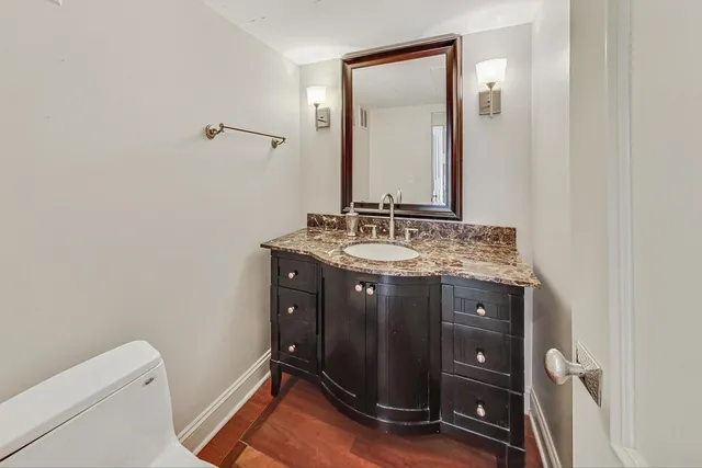 a bathroom with a sink vanity and a mirror