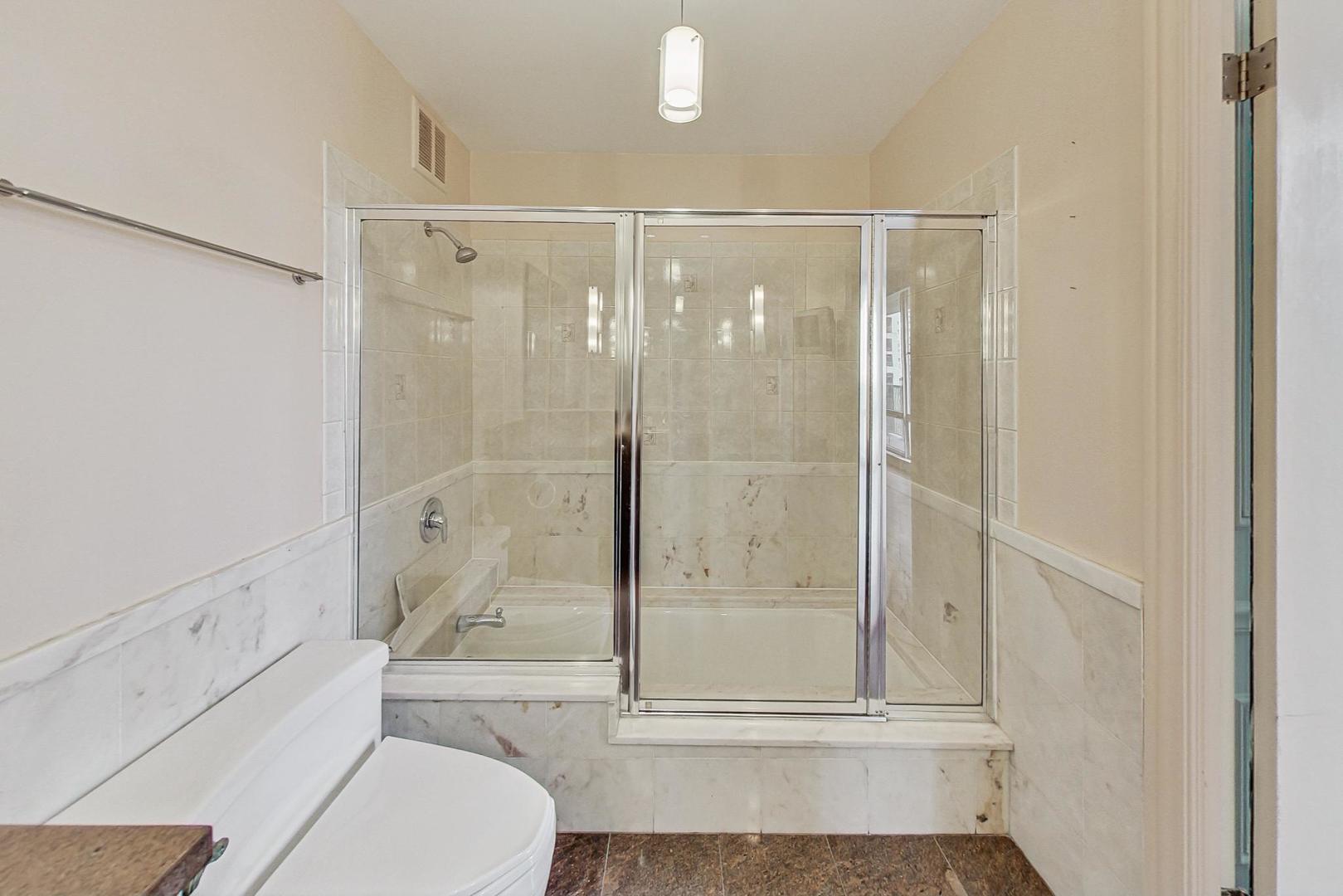 1040 North Lake Shore Drive, Unit 7B Chicago, IL 60611 - Photo 31 of 45 a bathroom with a shower a toilet and sink