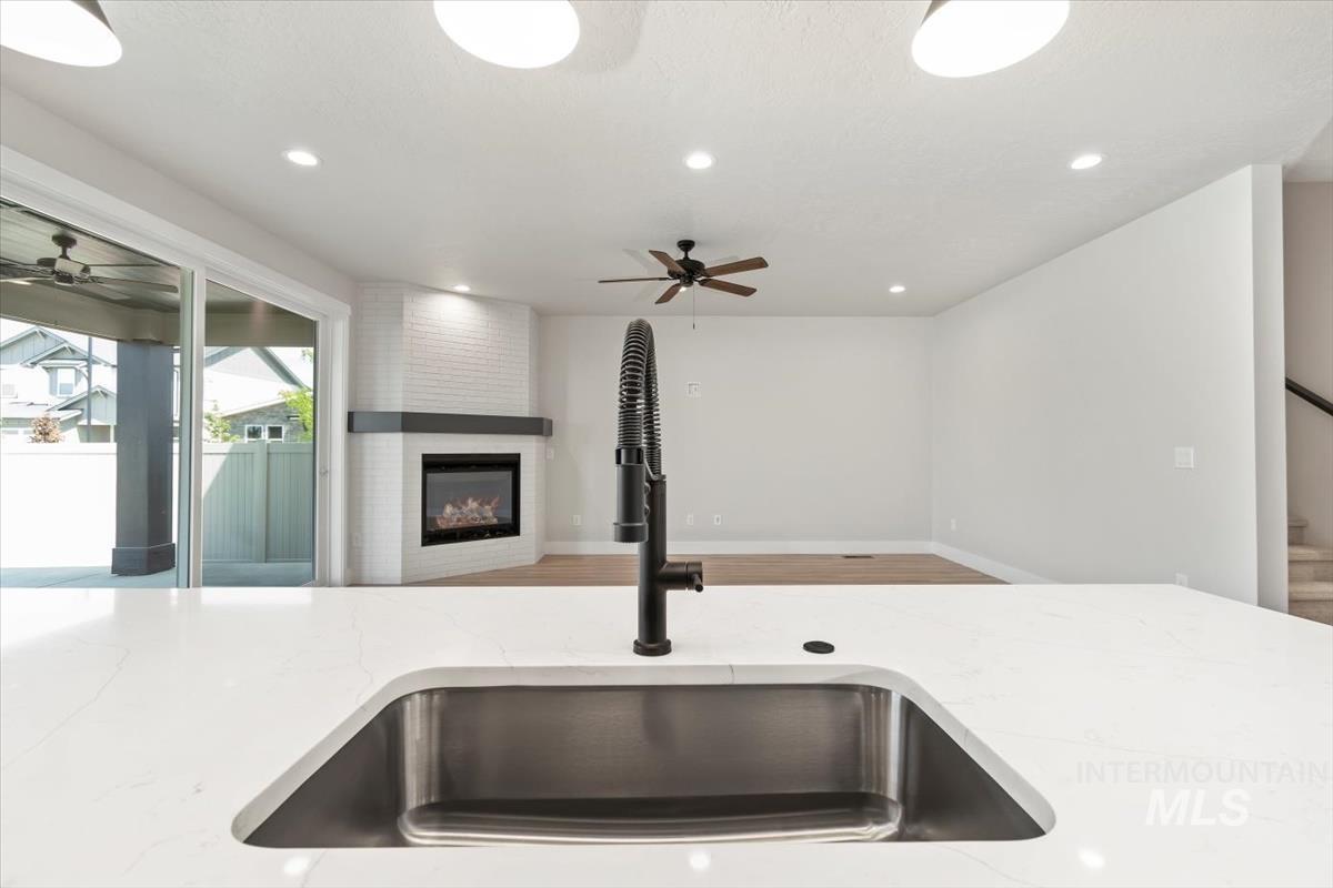 2830 West Jutland Street Meridian, ID 83642 - Photo 40 of 40 Kitchen with light stone countertops, a ceiling fan, recessed lighting, and open floor plan