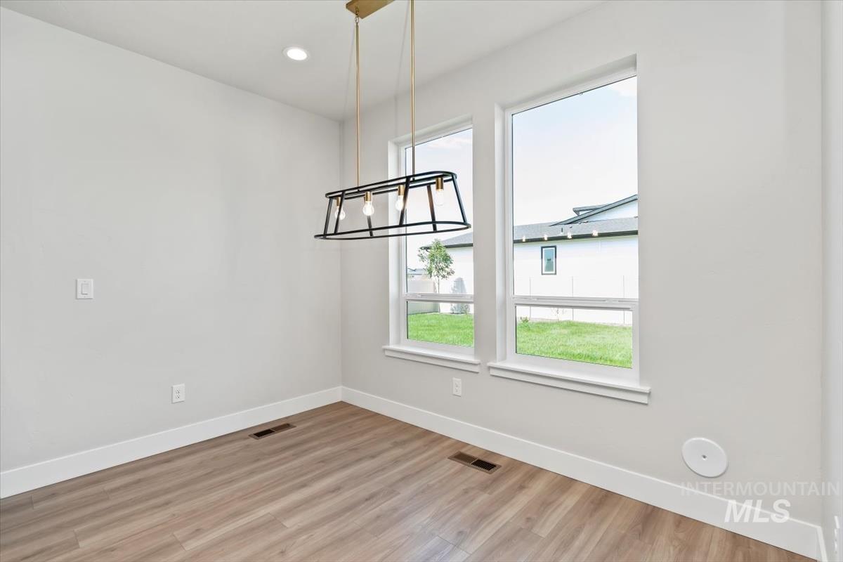 2830 West Jutland Street Meridian, ID 83642 - Photo 13 of 40 Unfurnished dining area featuring light wood-type flooring, a chandelier, and recessed lighting