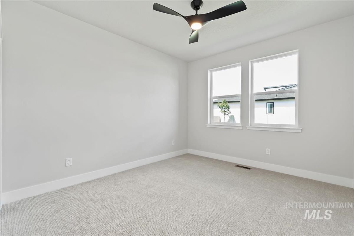 2830 West Jutland Street Meridian, ID 83642 - Photo 15 of 40 Unfurnished room with light colored carpet and ceiling fan