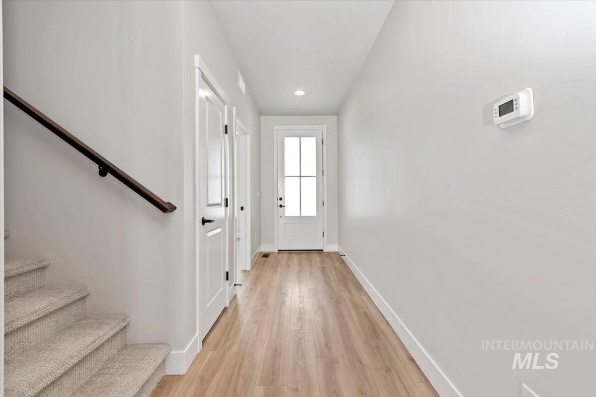 2830 West Jutland Street Meridian, ID 83642 - Photo 19 of 40 Doorway featuring stairway, wood finished floors, and recessed lighting