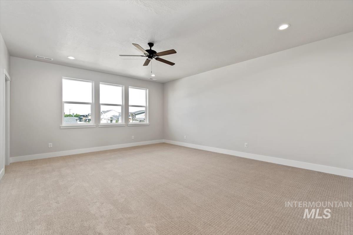 2830 West Jutland Street Meridian, ID 83642 - Photo 20 of 40 Empty room with recessed lighting, light carpet, and a ceiling fan