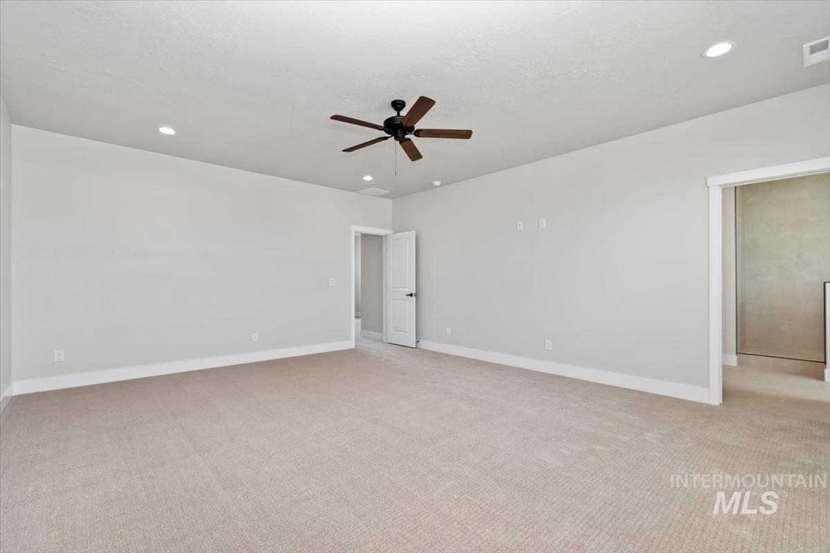 2830 West Jutland Street Meridian, ID 83642 - Photo 21 of 40 Spare room with light carpet, recessed lighting, and a ceiling fan