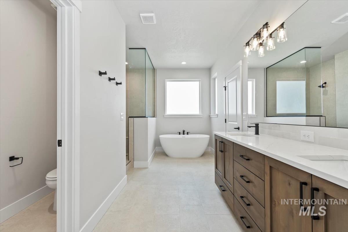 2830 West Jutland Street Meridian, ID 83642 - Photo 23 of 40 Bathroom with a freestanding bath, double vanity, and a stall shower