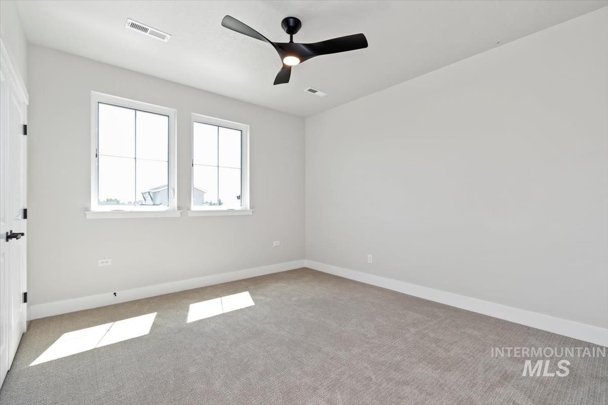 2830 West Jutland Street Meridian, ID 83642 - Photo 28 of 40 Carpeted spare room featuring baseboards and ceiling fan