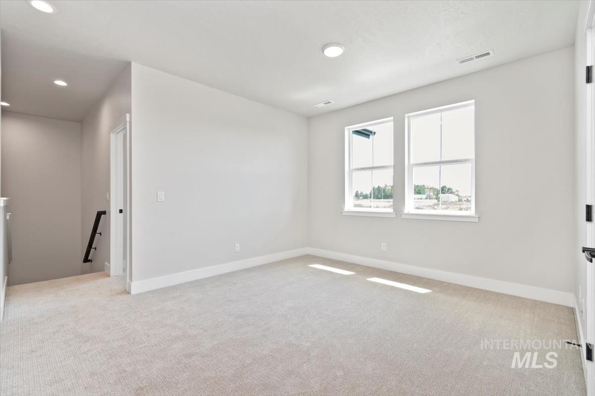 2830 West Jutland Street Meridian, ID 83642 - Photo 29 of 40 Empty room featuring light carpet and recessed lighting