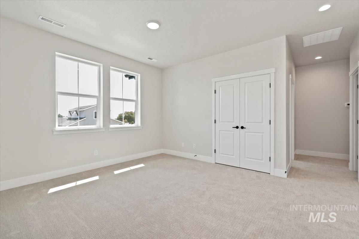 2830 West Jutland Street Meridian, ID 83642 - Photo 30 of 40 Unfurnished bedroom with light carpet, a closet, and recessed lighting