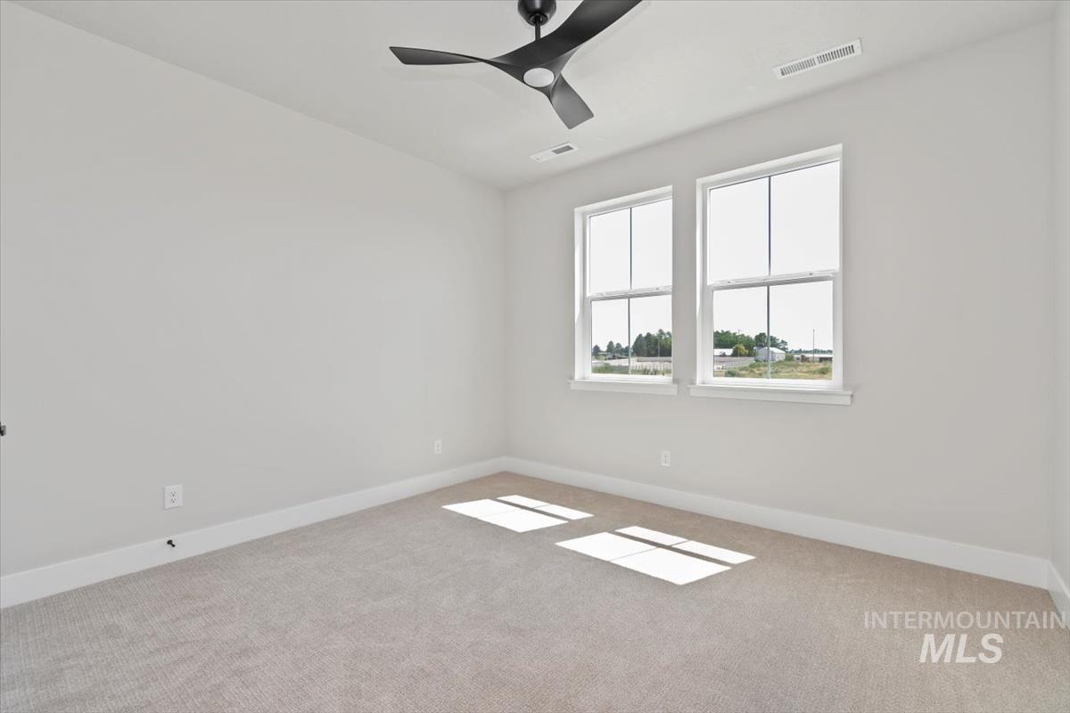 2830 West Jutland Street Meridian, ID 83642 - Photo 31 of 40 Unfurnished room featuring light carpet and a ceiling fan
