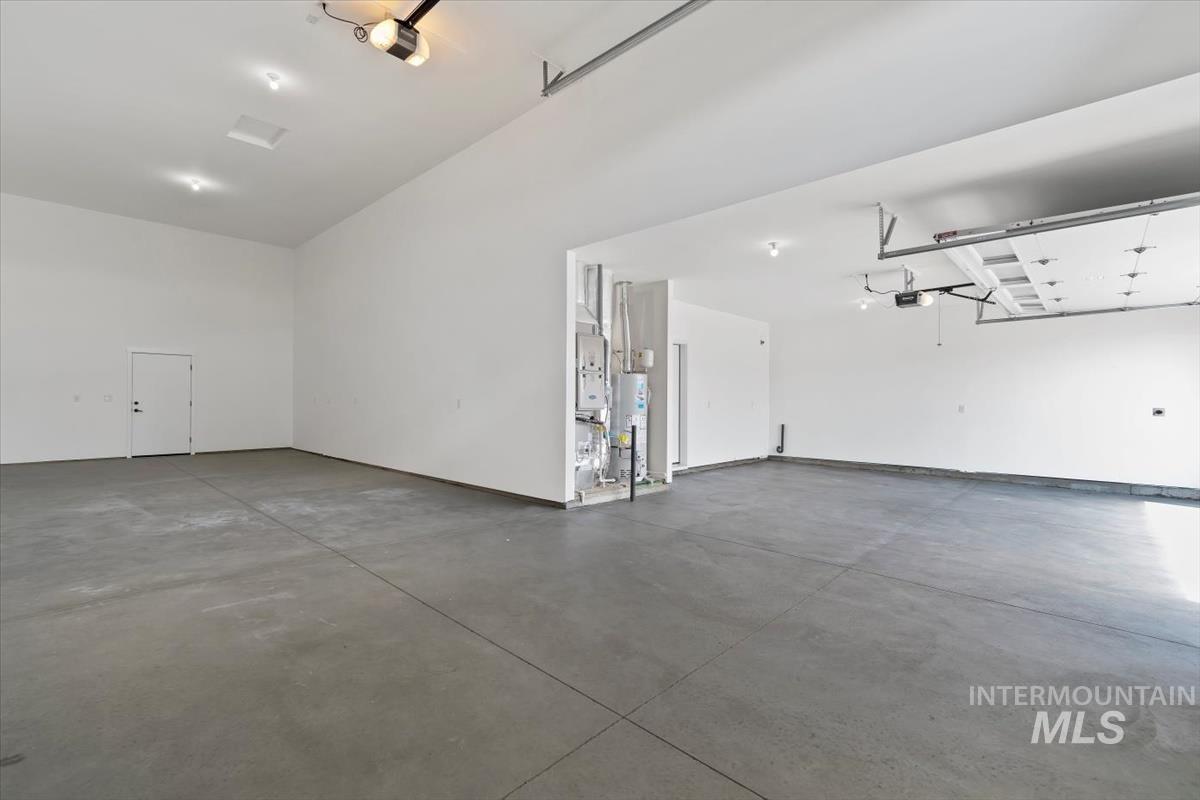 2830 West Jutland Street Meridian, ID 83642 - Photo 36 of 40 Garage featuring water heater and a garage door opener