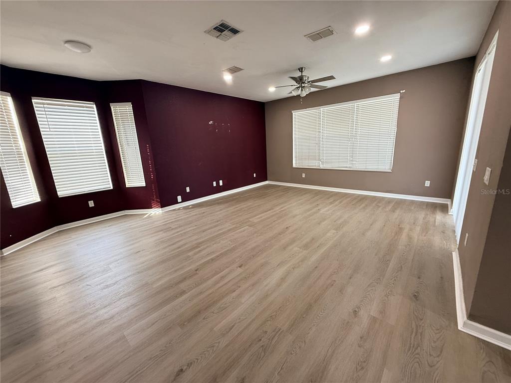 4199 Southwest 46th Court Ocala, FL 34474 - Photo 20 of 50 a view of an empty room with wooden floor and a window
