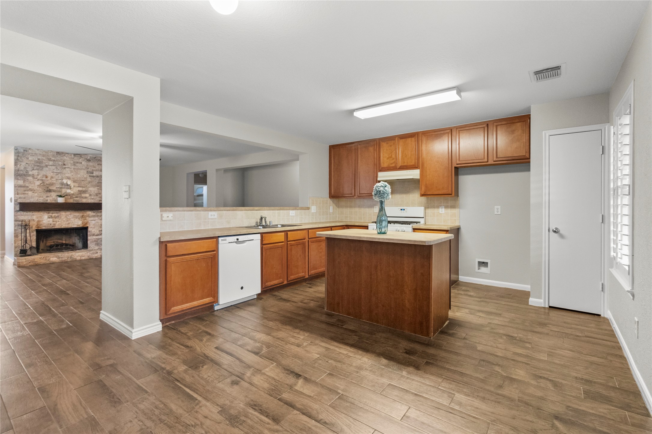 7922 Owl Lane Baytown, TX 77523 - Photo 15 of 25 a kitchen with a sink cabinets and wooden floor
