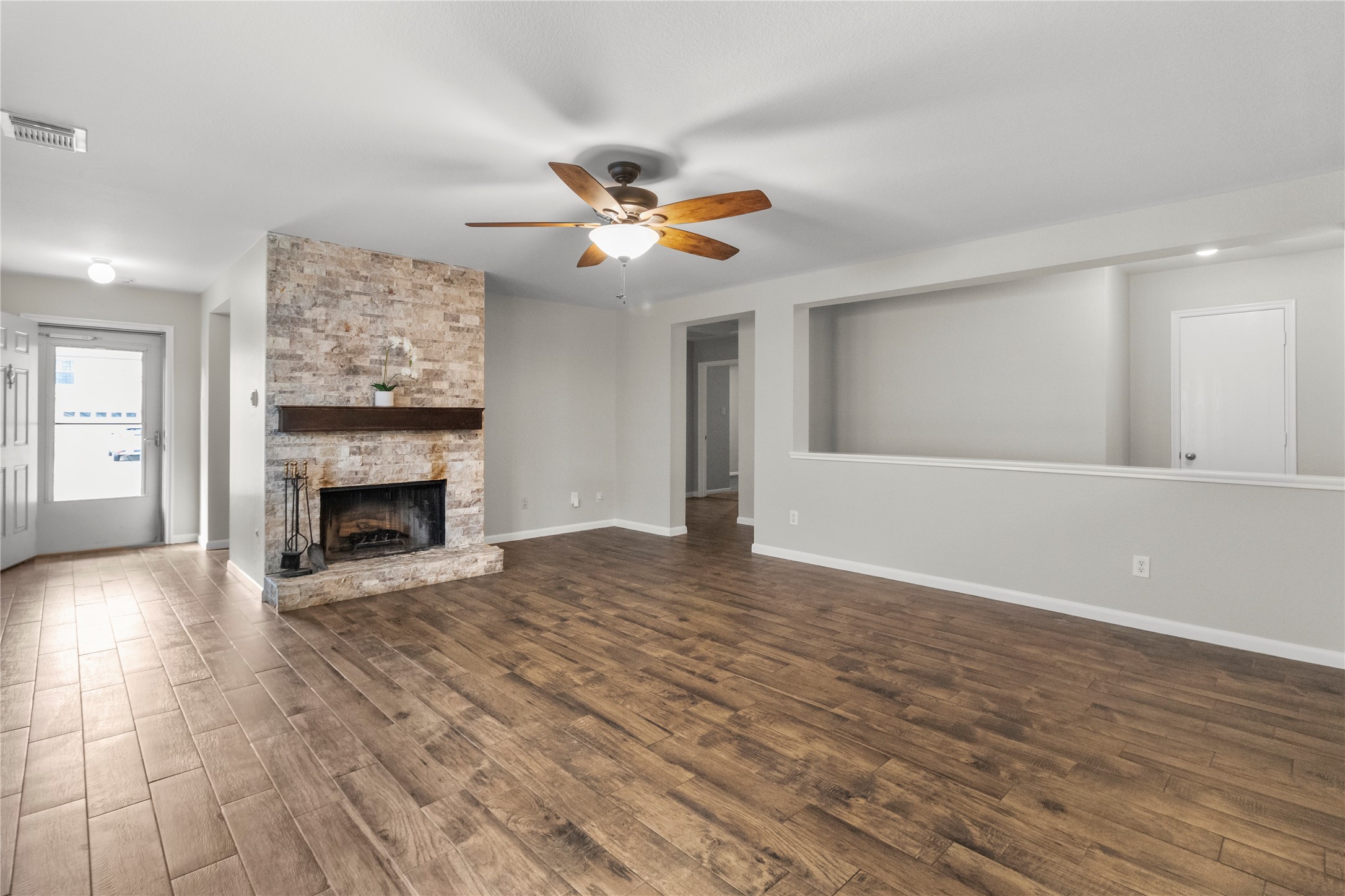 7922 Owl Lane Baytown, TX 77523 - Photo 3 of 25 a view of a livingroom with a fireplace a ceiling fan and wooden floor