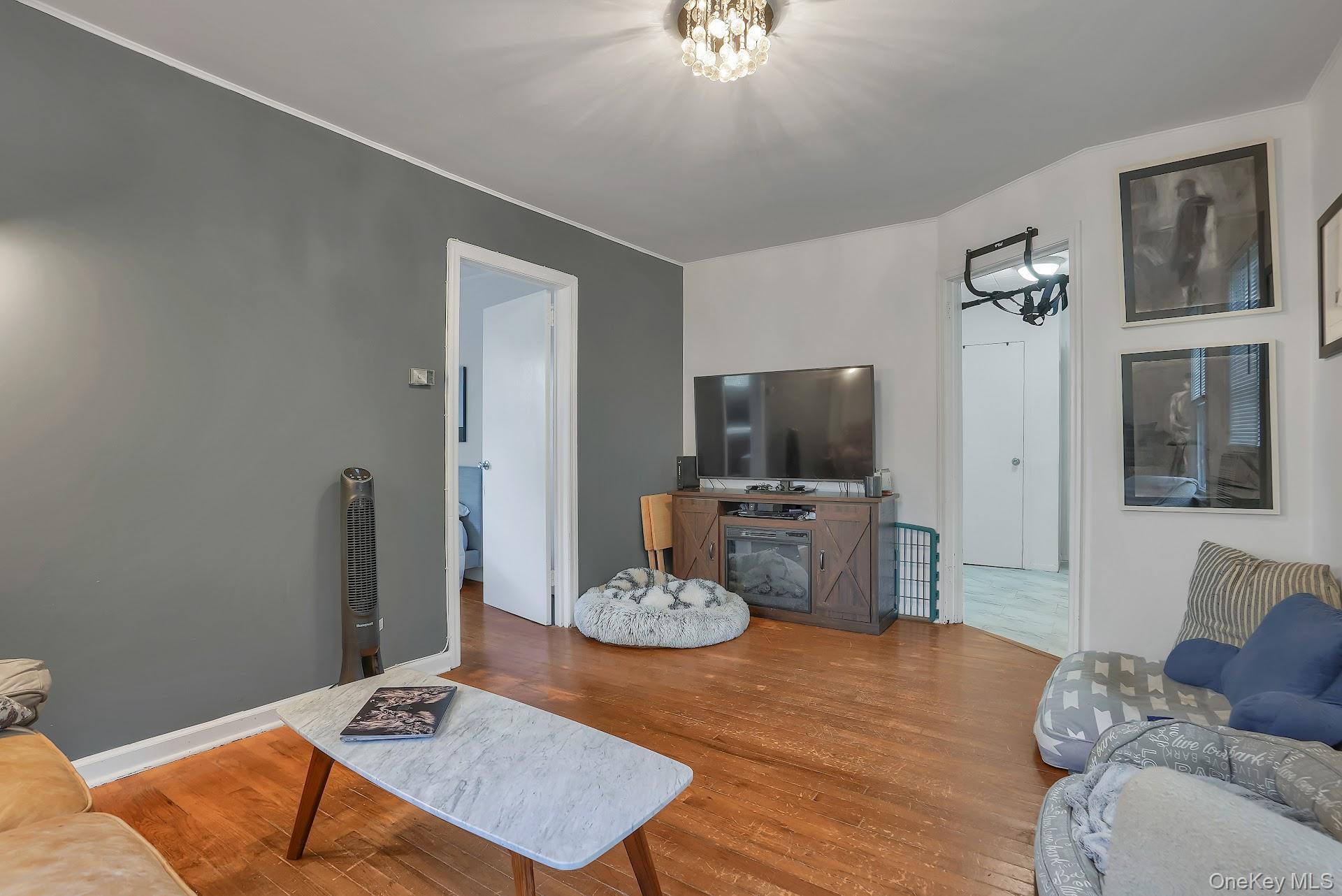 71 Greycourt Road Chester, NY 10918 - Photo 13 of 38 Living room featuring wood finished floors and a chandelier