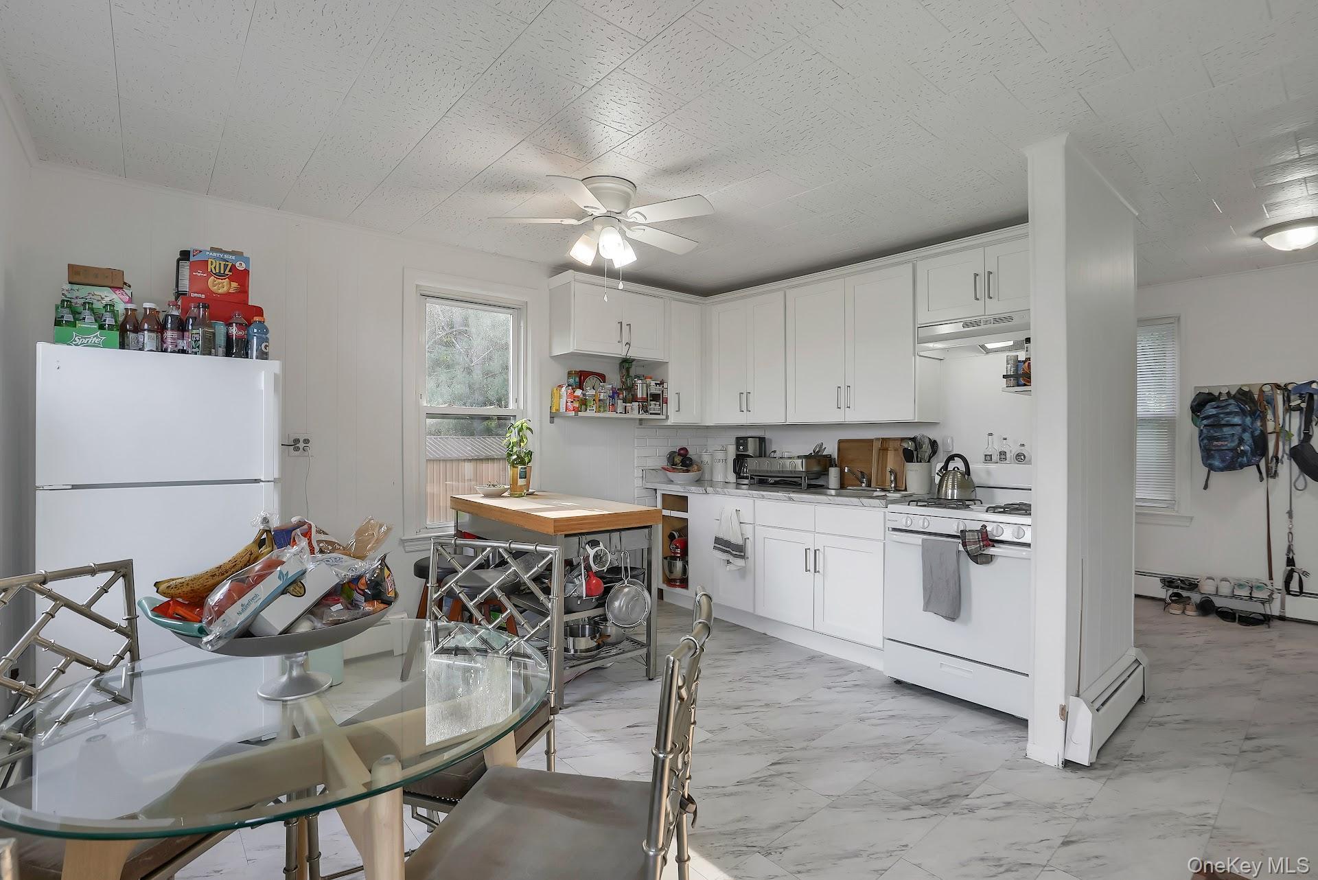 71 Greycourt Road Chester, NY 10918 - Photo 18 of 38 Kitchen featuring light marble finish flooring, white appliances, light countertops, white cabinets, and under cabinet range hood
