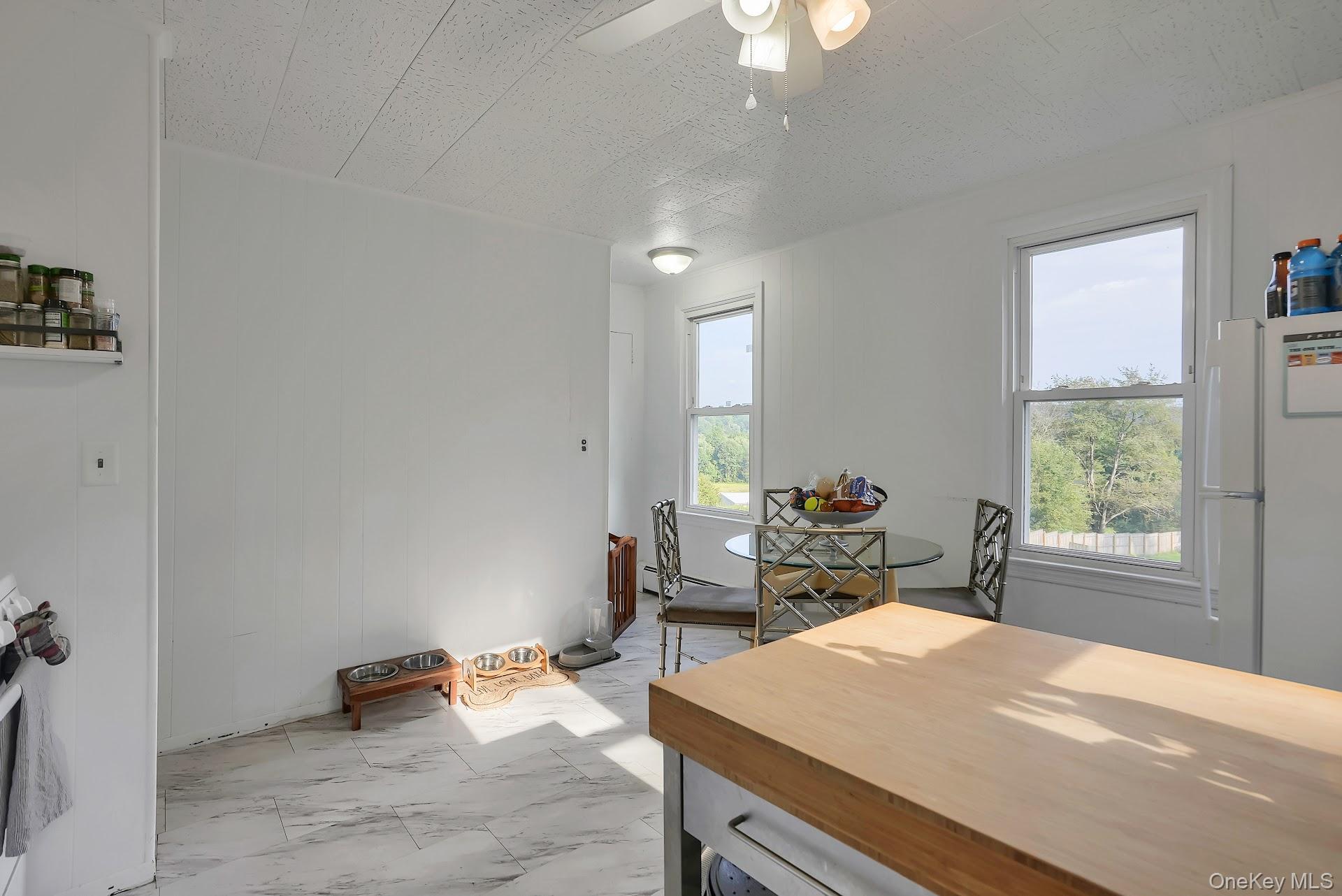 71 Greycourt Road Chester, NY 10918 - Photo 21 of 38 Dining space featuring a textured ceiling, light marble finish floors, and ceiling fan