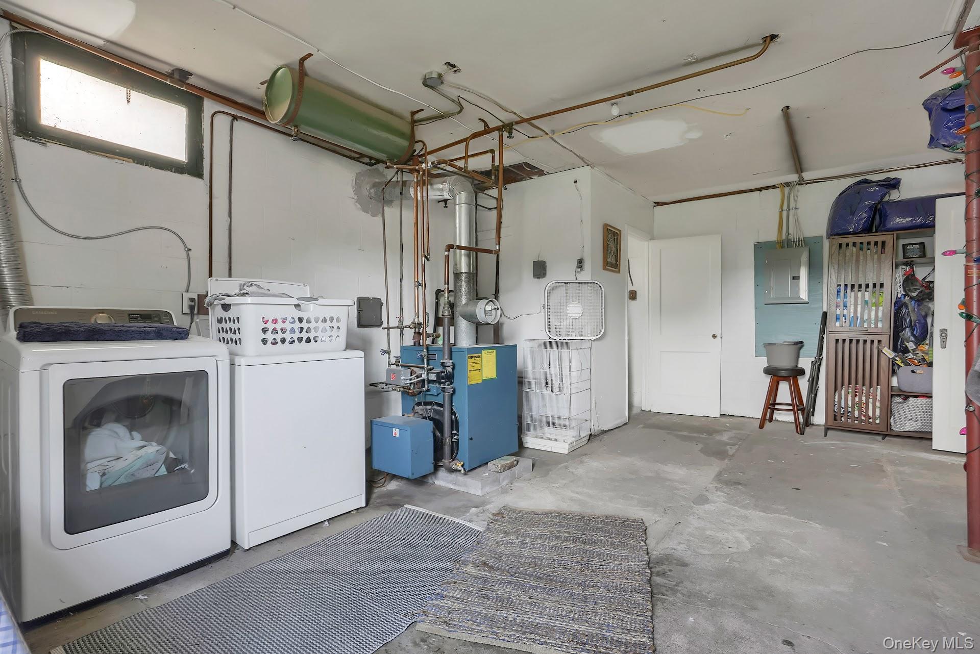 71 Greycourt Road Chester, NY 10918 - Photo 29 of 38 Laundry room with unfinished concrete flooring, electric panel, and separate washer and dryer