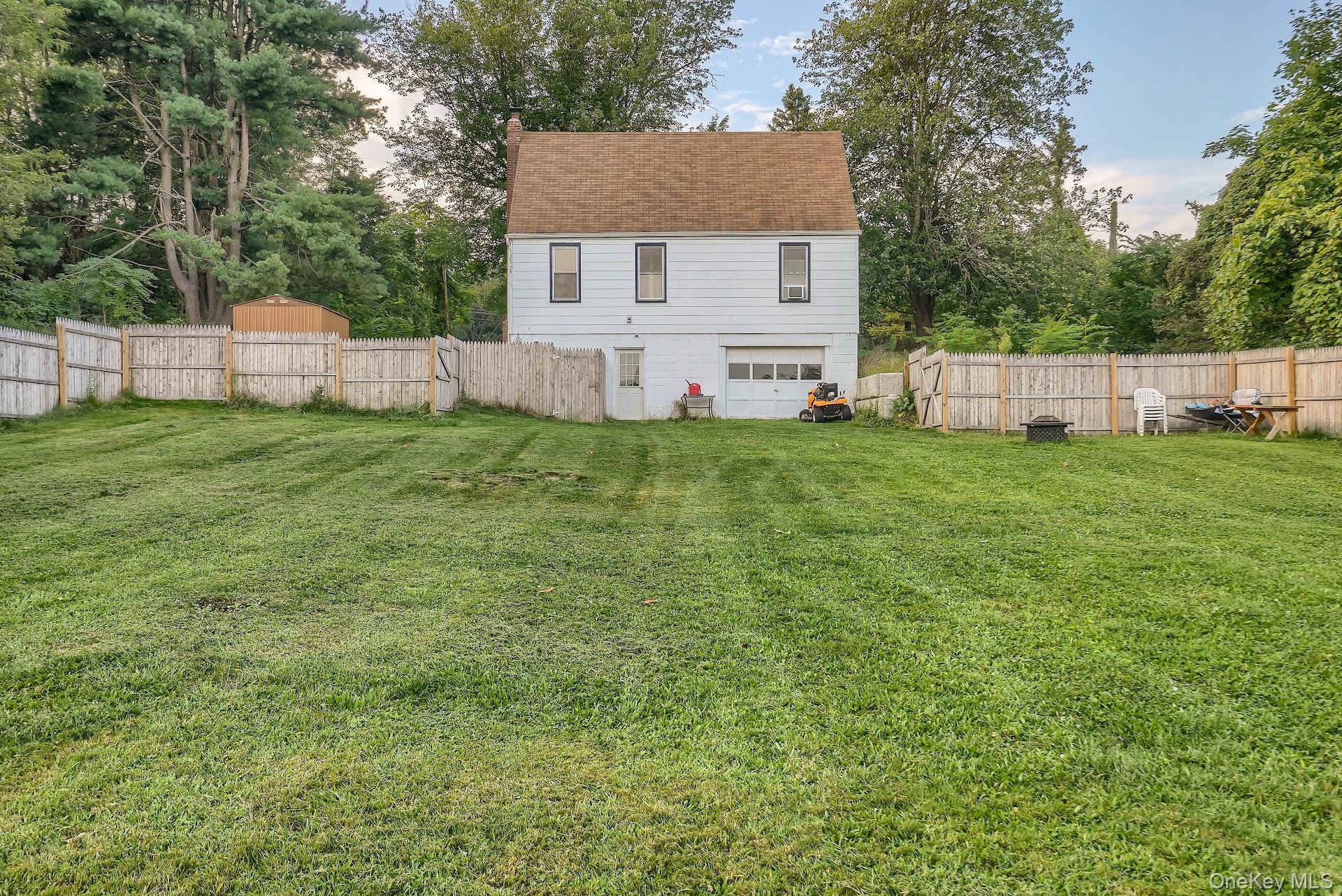 71 Greycourt Road Chester, NY 10918 - Photo 36 of 38 Back of property featuring view of wooded area, a shingled roof, and a chimney
