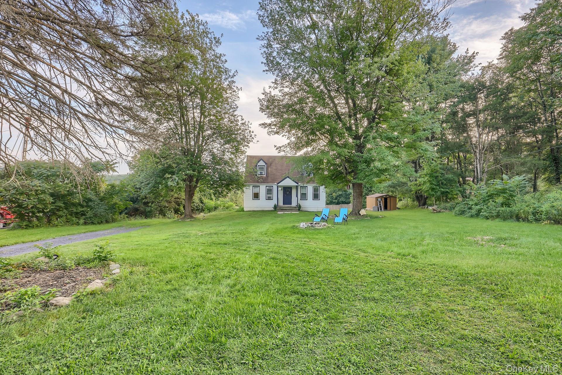 71 Greycourt Road Chester, NY 10918 - Photo 5 of 38 View of green lawn with a storage shed and view of scattered trees