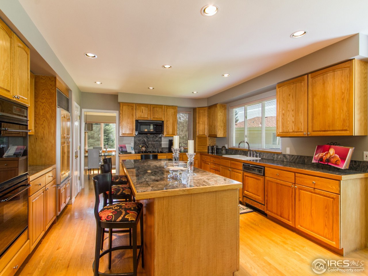 2512 Premier Place Boulder, CO 80304 - Photo 12 of 25 a kitchen with stainless steel appliances granite countertop sink stove refrigerator dining table and chairs