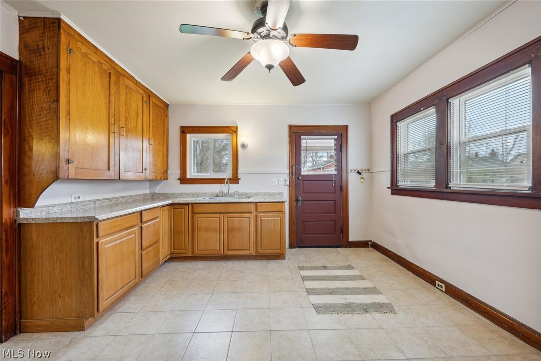64 West Bagley Road Berea, OH 44017 - Photo 16 of 48 Kitchen with ceiling fan, light counters, sink, and light tile floors