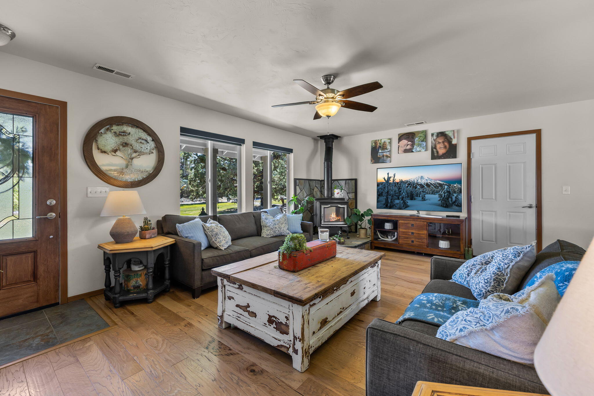 63639 Gentry Loop Bend, OR 97701 - Photo 8 of 40 a living room with furniture a clock two couches and a large window