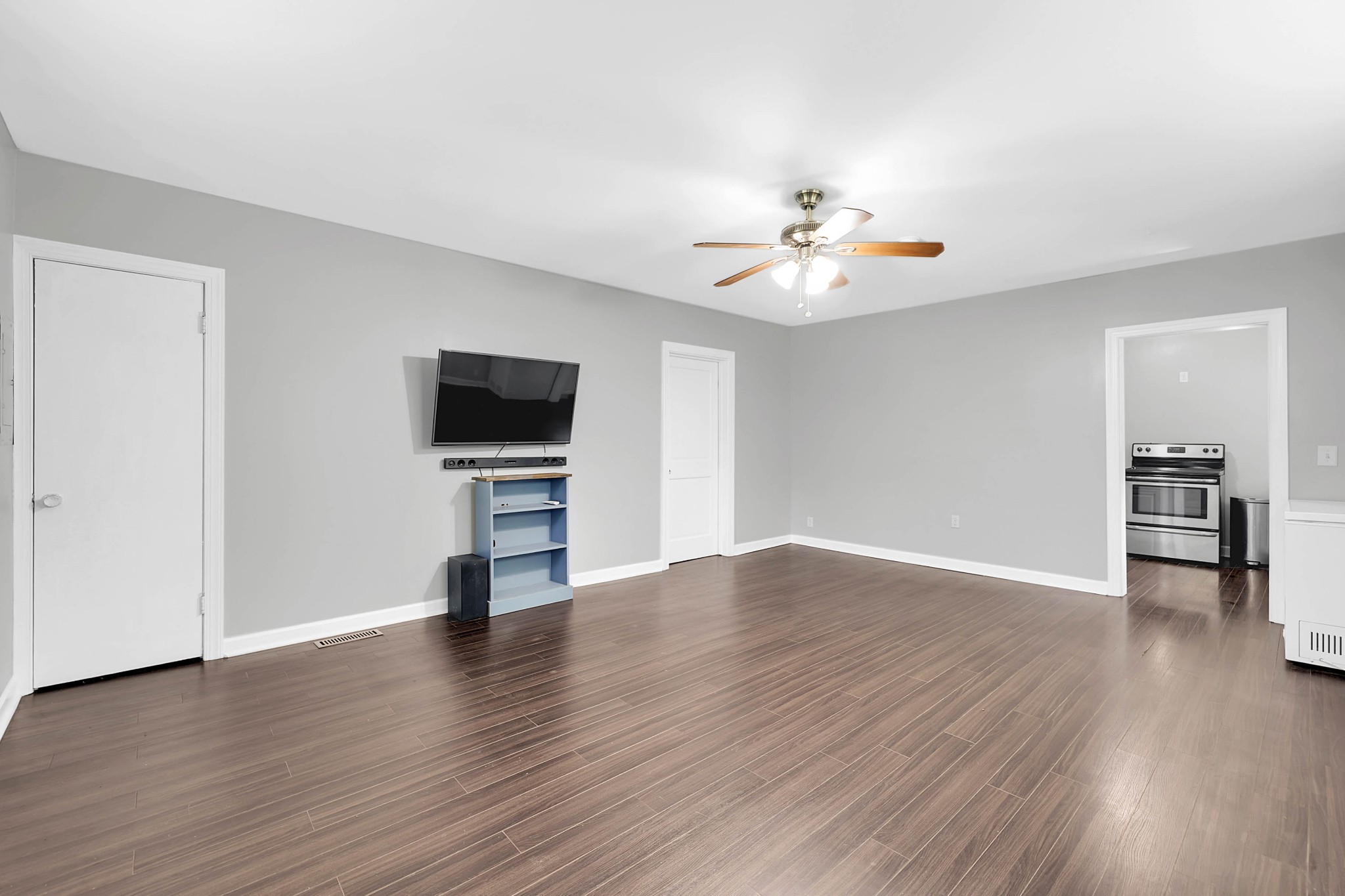 2812 Hastings Road Nashville, TN 37214 - Photo 17 of 32 a view of a livingroom with a flat screen tv wooden floor and a ceiling fan