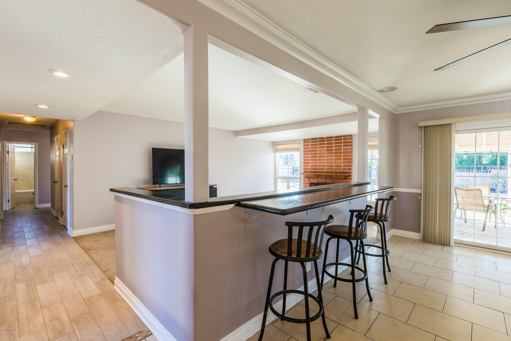 3441 Corpus Christi Street Simi Valley, CA 93063 - Photo 11 of 64 a kitchen with stainless steel appliances kitchen island granite countertop a table chairs and a refrigerator