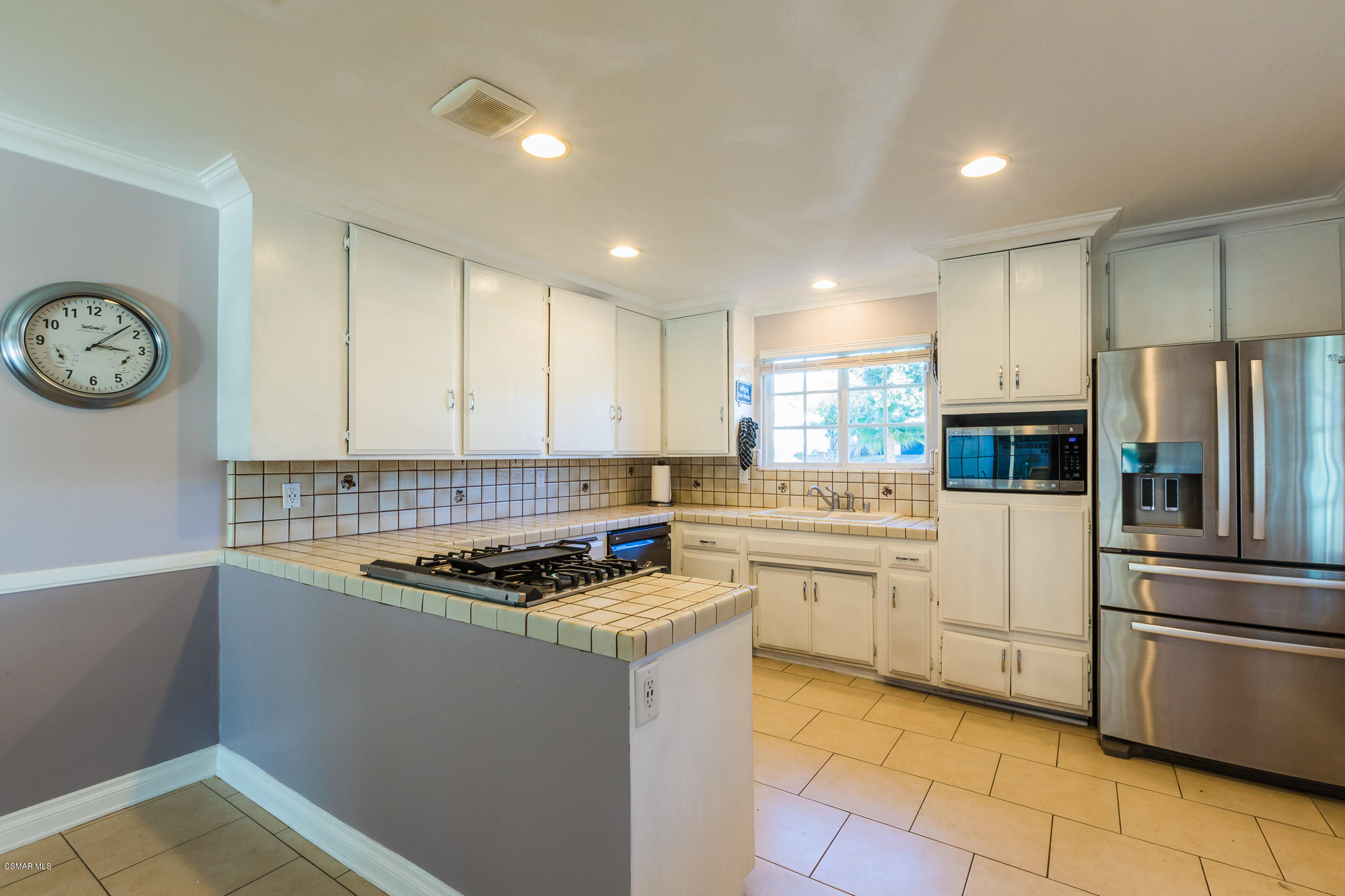 3441 Corpus Christi Street Simi Valley, CA 93063 - Photo 19 of 64 a kitchen with a refrigerator a stove top oven and a sink
