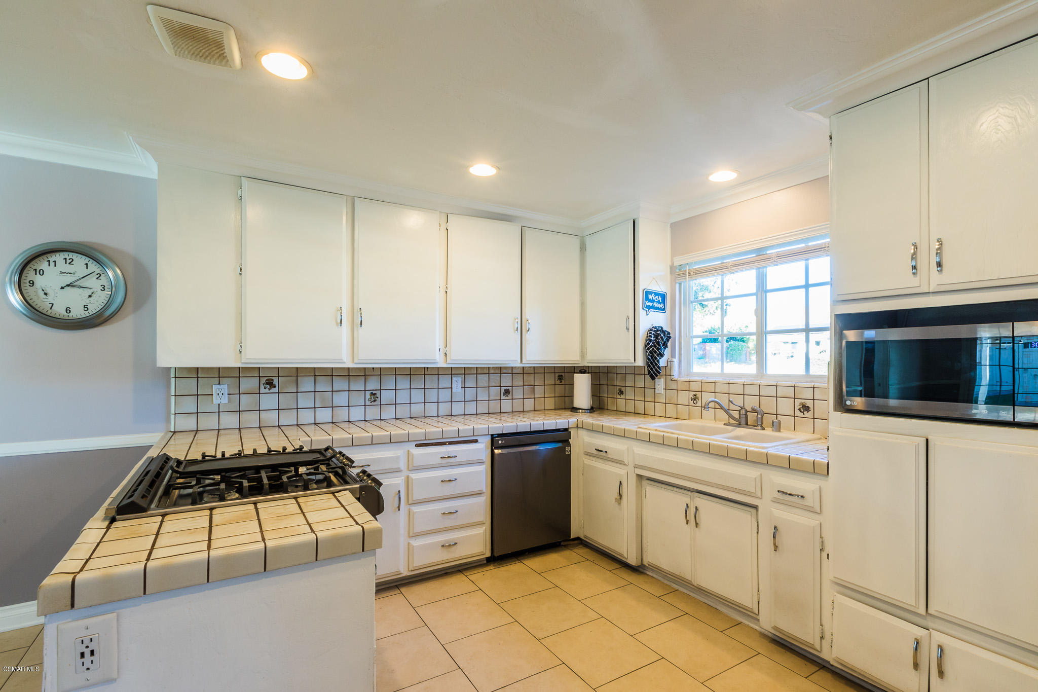 3441 Corpus Christi Street Simi Valley, CA 93063 - Photo 23 of 64 a kitchen with a stove sink and cabinets