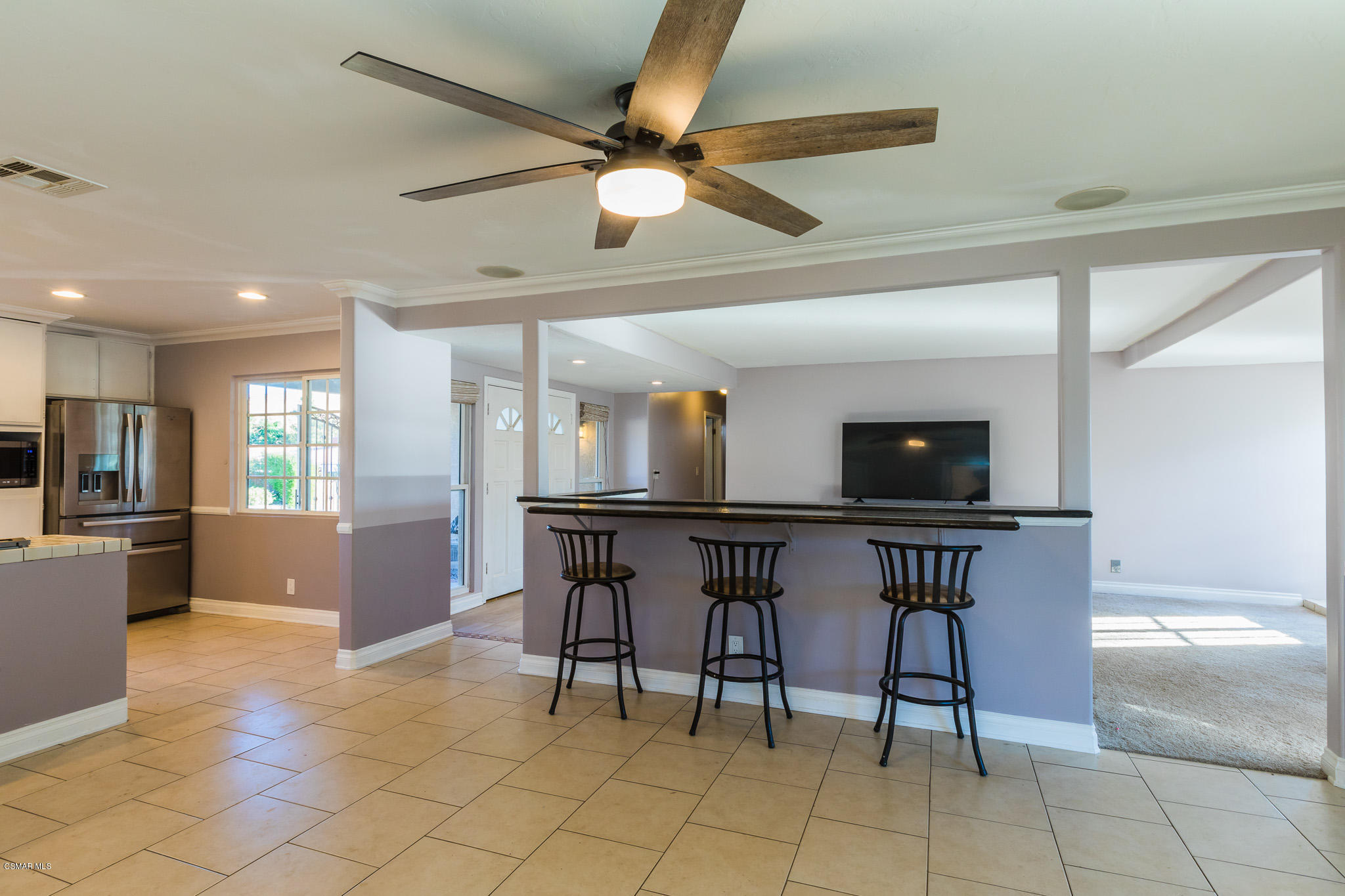 3441 Corpus Christi Street Simi Valley, CA 93063 - Photo 30 of 64 a kitchen with stainless steel appliances a dining table chairs and a refrigerator