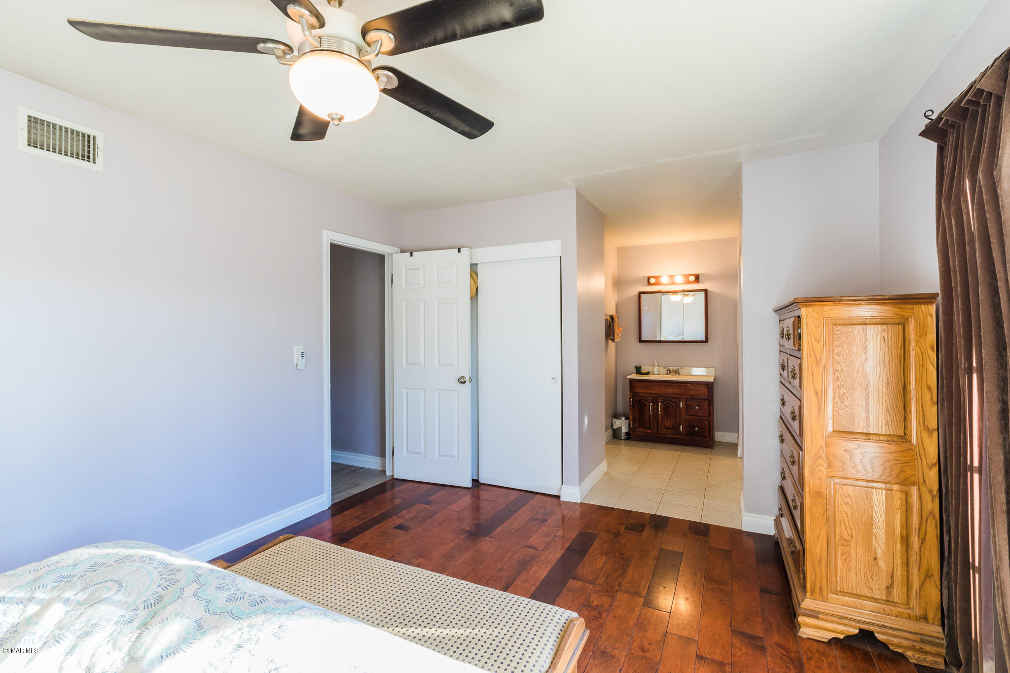 3441 Corpus Christi Street Simi Valley, CA 93063 - Photo 41 of 64 a view of a bedroom with wooden floor a ceiling fan and a kitchen space