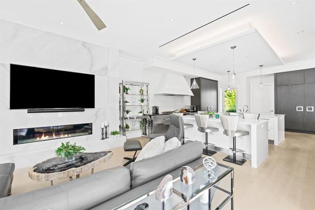 a dining room with furniture and large window