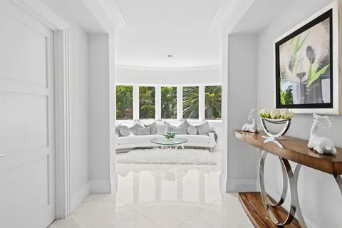 a bedroom with a bed lamp and a large window