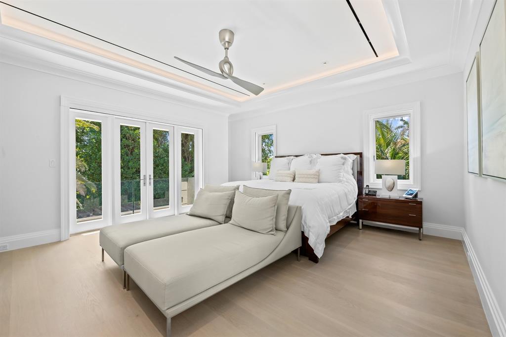 150 Kings Road Palm Beach, FL 33480 - Photo 17 of 45 a bedroom with a bed lamp and a large window