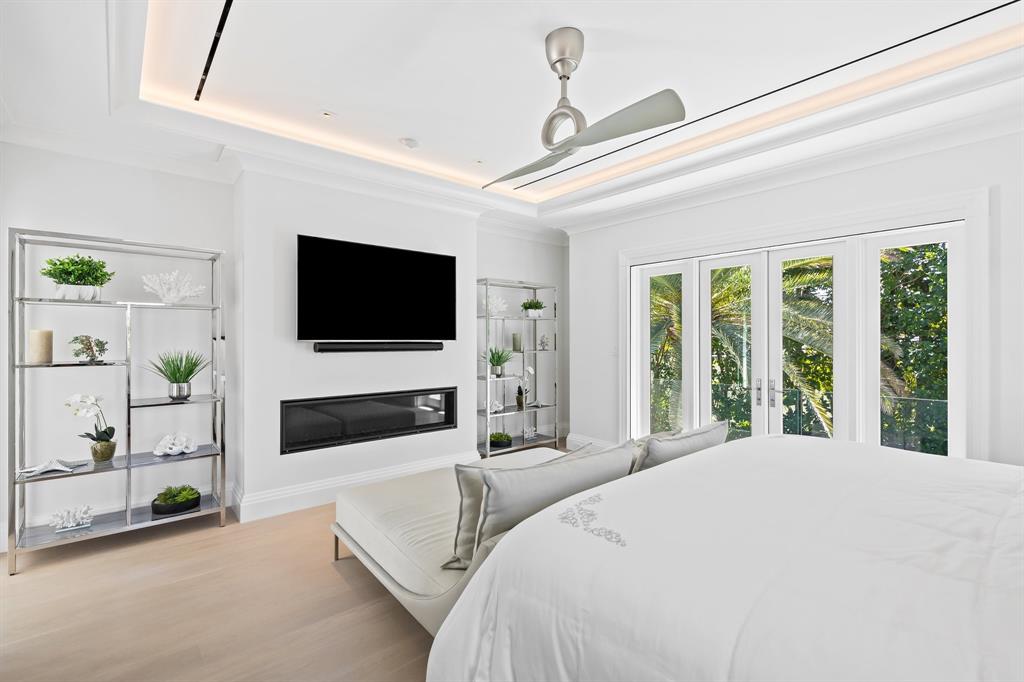 150 Kings Road Palm Beach, FL 33480 - Photo 18 of 45 a bedroom with a bed a flat screen tv and a large window