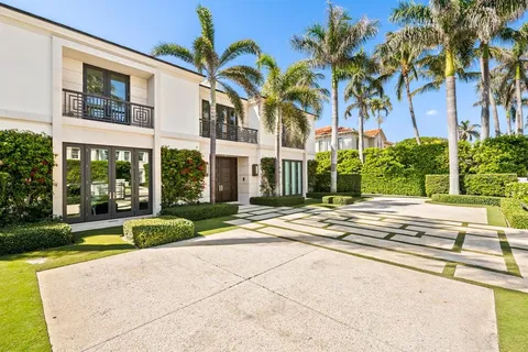 a view of swimming pool with palm trees
