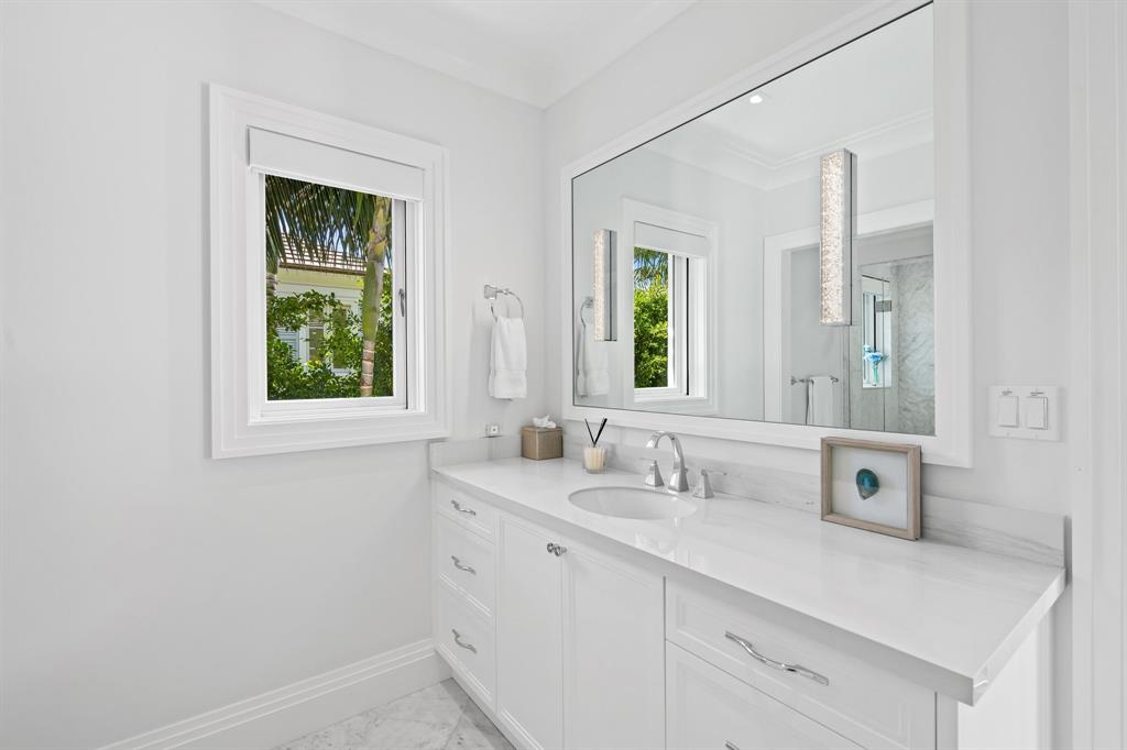 150 Kings Road Palm Beach, FL 33480 - Photo 30 of 45 a bathroom with a sink and a mirror