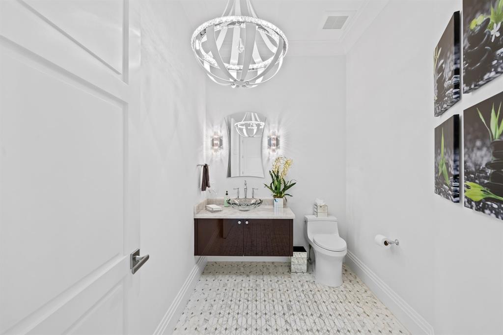 150 Kings Road Palm Beach, FL 33480 - Photo 32 of 45 a bathroom with a toilet a sink and a mirror